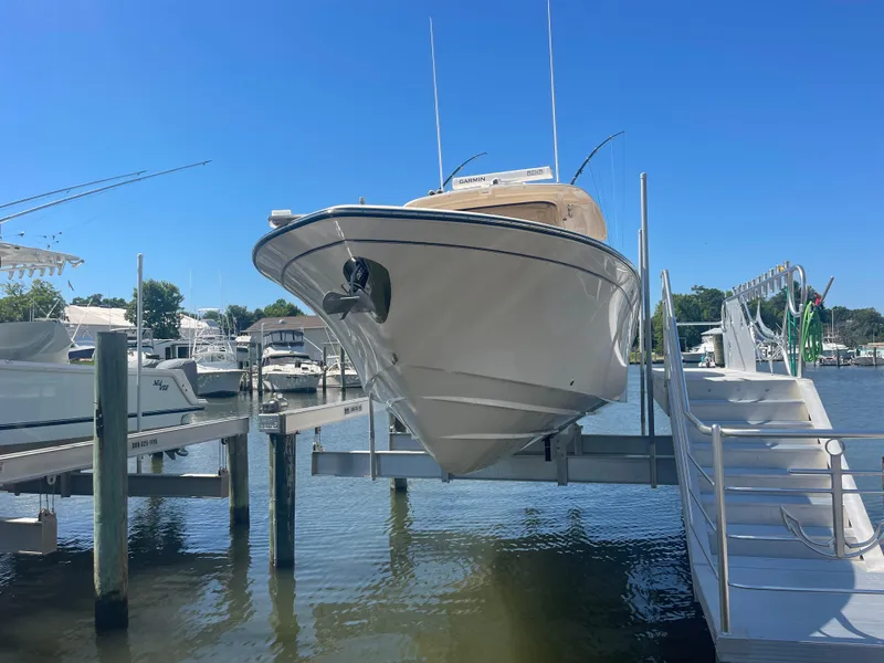 Slide: The Image of 2021 Grady-White Canyon 326 boat docked at marina. - 4