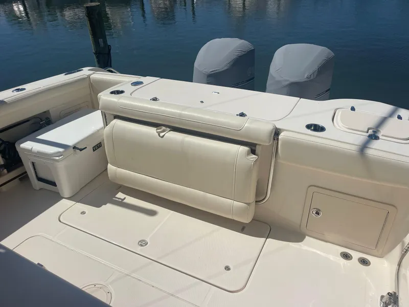 Slide: The Image of Grady-White Canyon 326 boat rear, 2021 model, featuring seating and engine covers. - 7