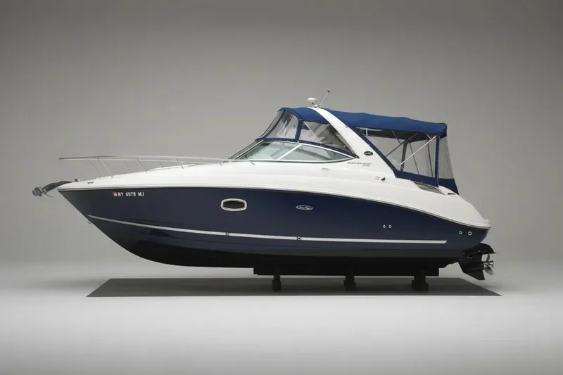 The Image of 2009 Sea Ray 270 Sundancer boat with blue and white exterior, side view. - 0