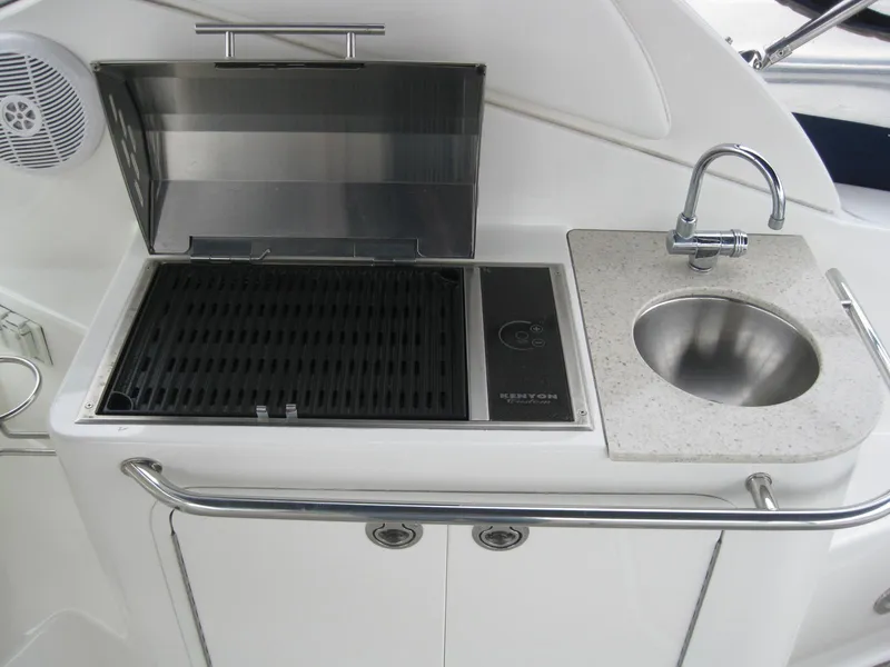 Slide: The Image of Kitchen area on 2009 Sea Ray 270 Sundancer with grill and sink. - 13