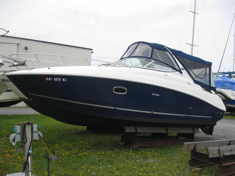 Slide: The Image of 2009 Sea Ray 270 Sundancer boat on a dock. - 2