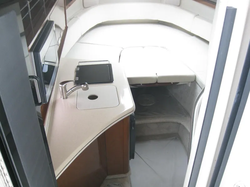 Slide: The Image of Interior of 2009 Sea Ray 270 Sundancer with sleeping area and sink. - 22
