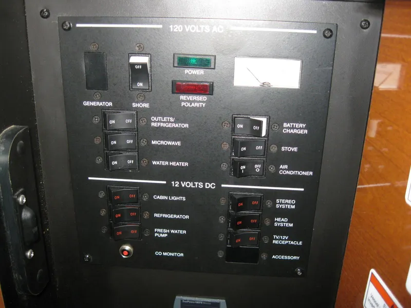 Slide: The Image of Sea Ray 270 Sundancer 2009 control panel with circuit switches. - 34
