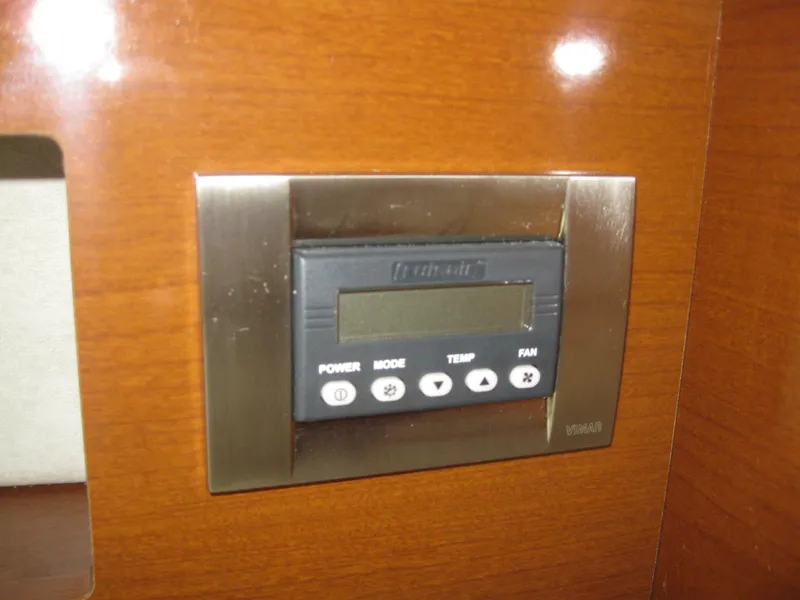 Slide: The Image of Control panel on 2009 Sea Ray 270 Sundancer, wood paneling. - 36