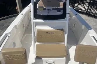 Slide: The Image of 2023 Trophy T24 CC boat interior with beige seating and console. - 10