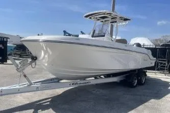 Slide: The Image of 2023 Trophy T24 CC boat on trailer under clear blue sky. - 4