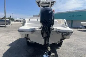 Slide: The Image of 2023 Trophy T24 CC boat with powerful outboard motor, parked outdoors. - 6