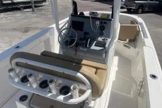 Slide: The Image of 2023 Trophy T24 CC boat interior with helm, seating, and rod holders. - 8