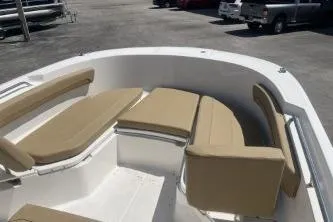 Slide: The Image of 2023 Trophy T24 CC boat interior with beige seating in a parking lot. - 9