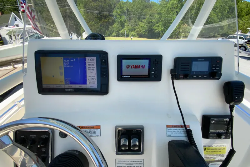 Slide: The Image of 2021 Cobia 220 Center Console dashboard with Garmin and Yamaha displays. - 13