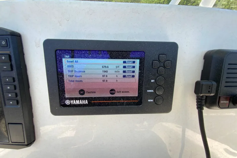 Slide: The Image of Yamaha display on 2021 Cobia 220 Center Console showing trip data and settings. - 14