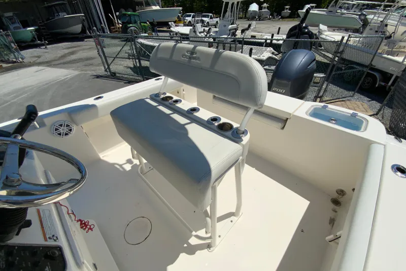 Slide: The Image of 2021 Cobia 220 Center Console boat interior with seating and steering wheel. - 15
