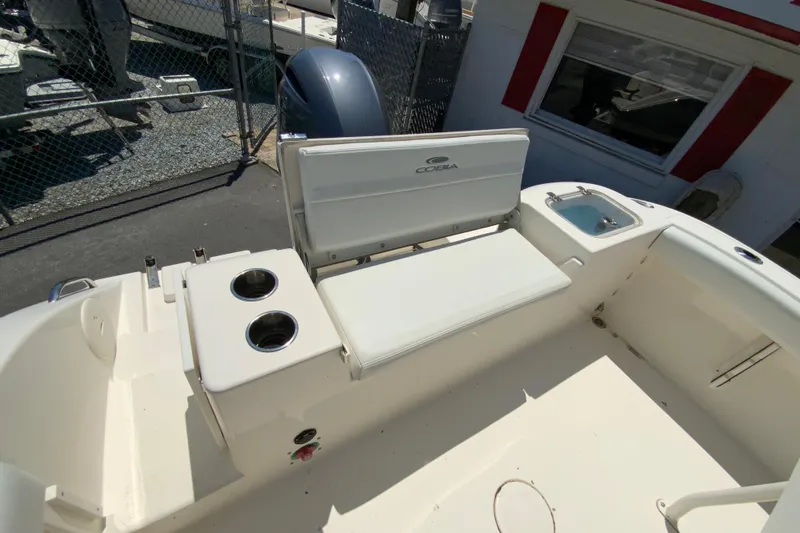 Slide: The Image of 2021 Cobia 220 Center Console boat interior with seating and cup holders. - 17