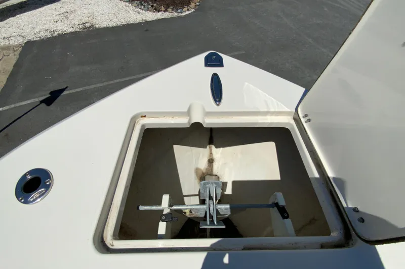 Slide: The Image of 2021 Cobia 220 Center Console anchor storage compartment open on deck. - 23