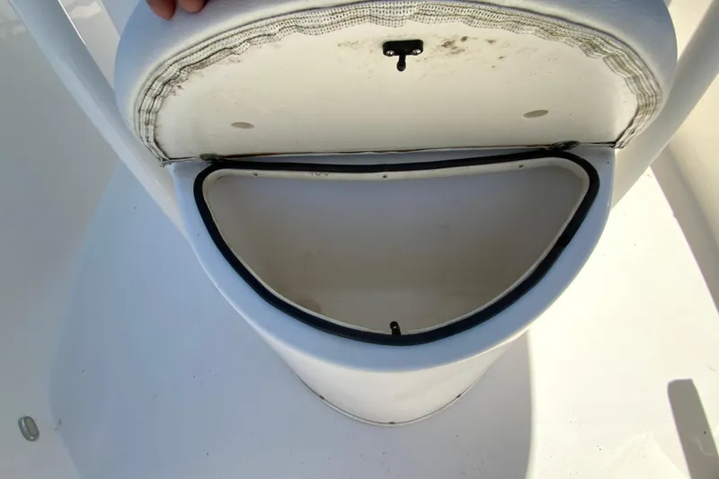 Slide: The Image of Open storage compartment on a 2021 Cobia 220 Center Console boat. - 25
