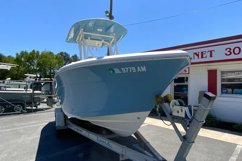 Slide: The Image of 2021 Cobia 220 Center Console boat on trailer, parked outside dealership. - 3