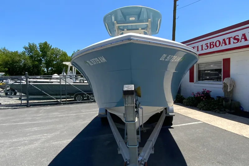 Slide: The Image of 2021 Cobia 220 Center Console boat on trailer, parked outside dealership. - 4
