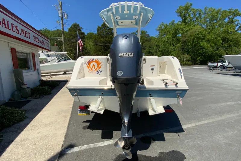 Slide: The Image of 2021 Cobia 220 Center Console boat with Yamaha 200 engine, parked outdoors. - 9