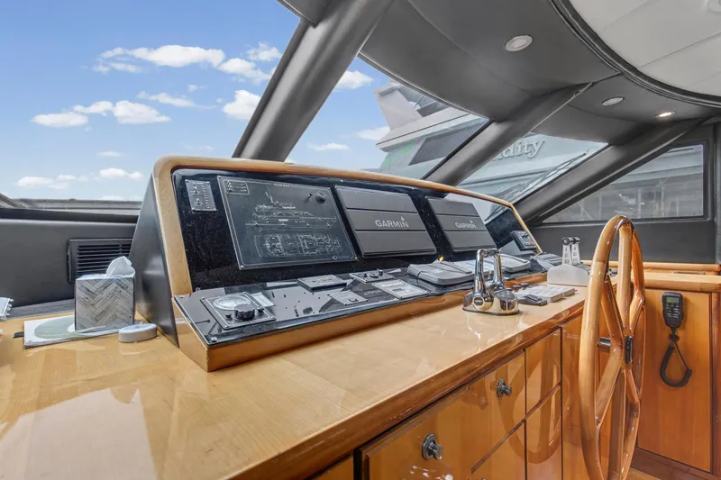 Slide: The Image of Cockpit of 2004 Queenship 76 Baretta yacht with navigation equipment and wooden steering wheel. - 13
