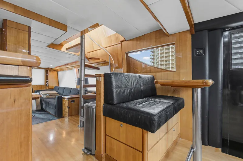 Slide: The Image of Luxurious interior of 2004 Queenship 76 Baretta yacht with modern seating and wood finishes. - 15