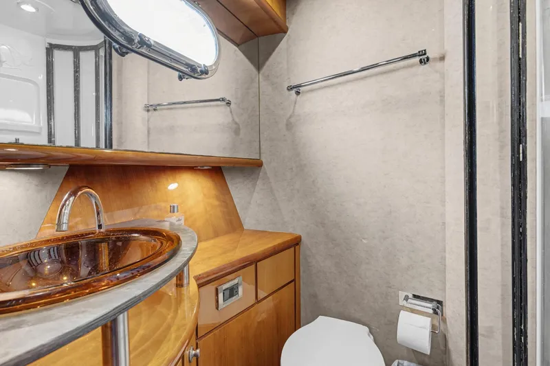 Slide: The Image of Luxurious bathroom in 2004 Queenship 76 Baretta yacht with elegant wood finishes. - 22