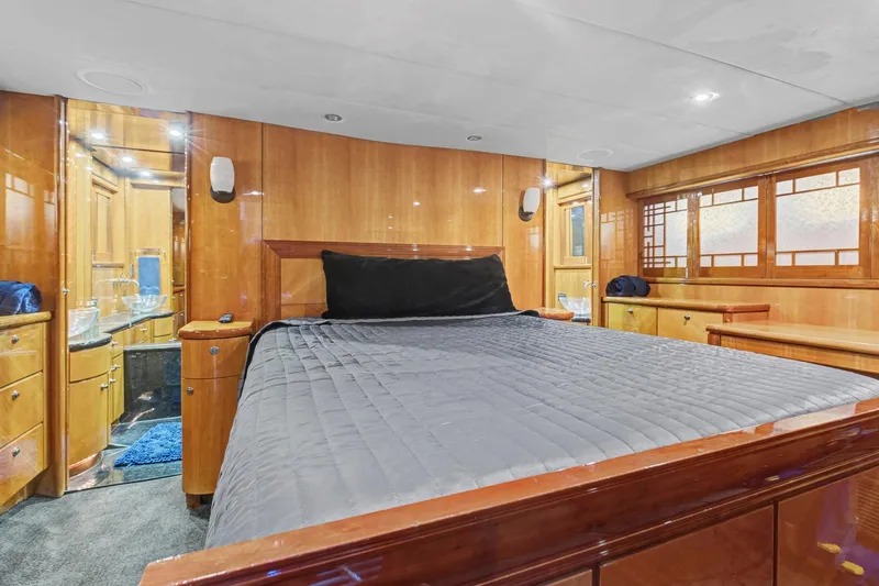 Slide: The Image of Luxurious bedroom interior of 2004 Queenship 76 Baretta yacht with wood paneling and modern amenities. - 24