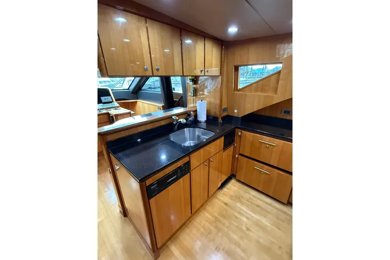 Slide: The Image of Luxurious kitchen interior of 2004 Queenship 76 Baretta yacht with wood cabinetry and modern appliances. - 40