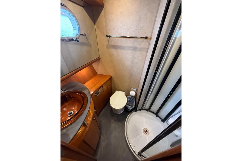Slide: The Image of Luxurious bathroom in 2004 Queenship 76 Baretta yacht with modern fixtures and elegant design. - 44