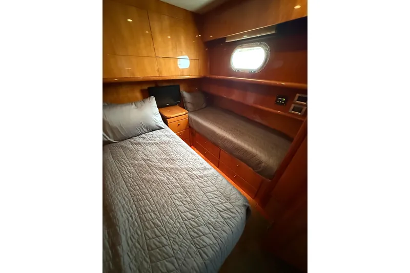 Slide: The Image of Luxurious 2004 Queenship 76 Baretta yacht cabin with twin beds and elegant wood finish. - 45
