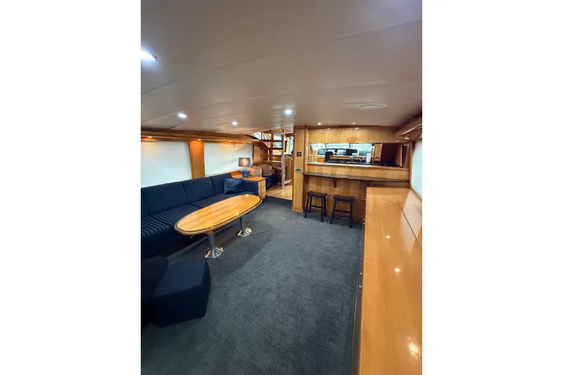 Slide: The Image of Luxurious interior of 2004 Queenship 76 Baretta yacht with elegant seating and wooden finishes. - 49