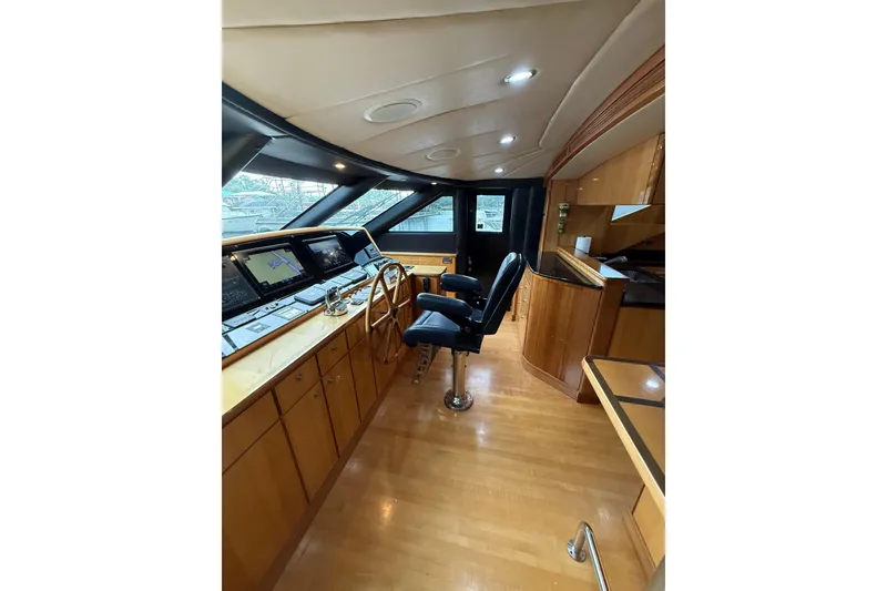 Slide: The Image of Luxurious 2004 Queenship 76 Baretta yacht interior with modern helm and wooden finishes. - 52
