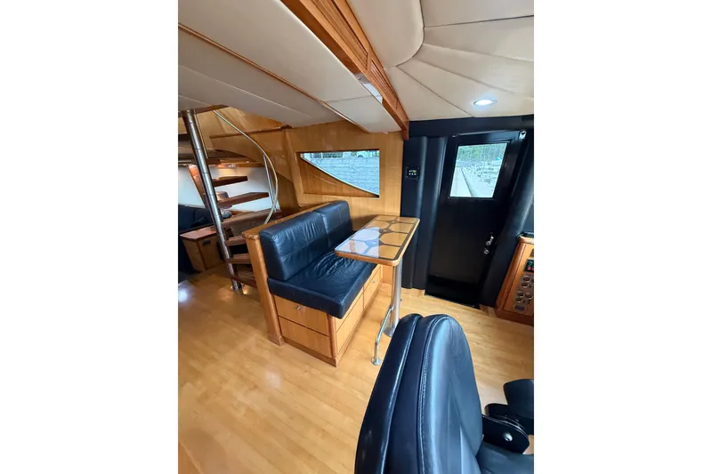 Slide: The Image of Interior of 2004 Queenship 76 Baretta yacht with wooden flooring and spiral staircase. - 53