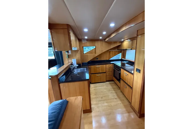 Slide: The Image of Luxurious wooden kitchen interior of 2004 Queenship 76 Baretta yacht with modern appliances. - 60