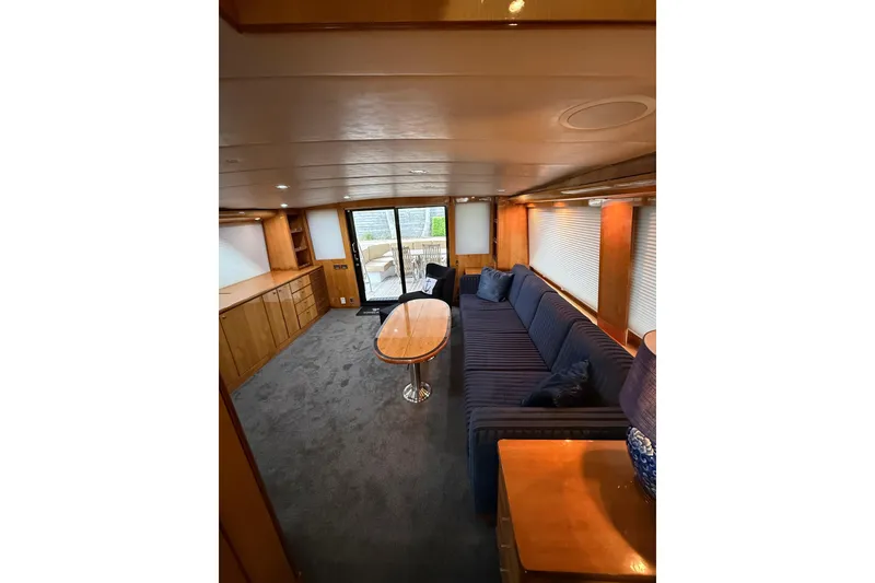 Slide: The Image of Luxurious interior of 2004 Queenship 76 Baretta yacht with plush seating and elegant wood finishes. - 61