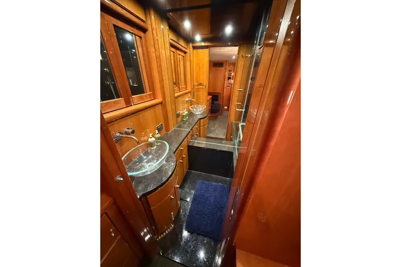 Slide: The Image of Luxurious bathroom interior of 2004 Queenship 76 Baretta yacht with elegant wood finishes. - 62