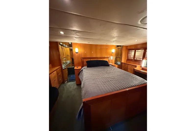 Slide: The Image of Luxurious bedroom interior of 2004 Queenship 76 Baretta yacht with wood paneling. - 63