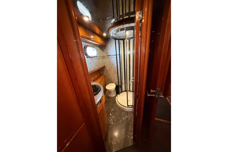 Slide: The Image of Luxurious bathroom in 2004 Queenship 76 Baretta yacht with shower and porthole window. - 64