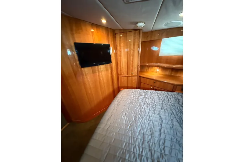 Slide: The Image of Luxurious cabin interior of 2004 Queenship 76 Baretta yacht with wood paneling and TV. - 65