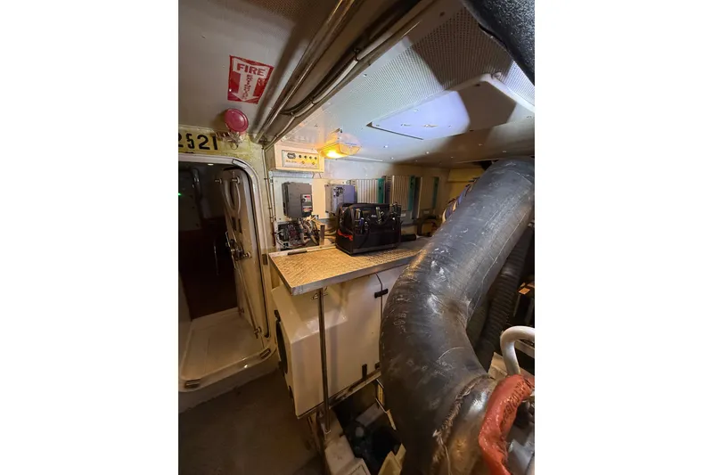 Slide: The Image of Engine room of 2004 Queenship 76 Baretta yacht with control panels and equipment. - 67