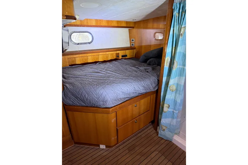 Slide: The Image of Cozy cabin interior of 2004 Queenship 76 Baretta yacht with wooden furnishings. - 72