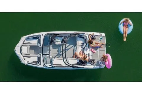 Slide: The Image of 2026 Yamaha Boats AR195 on water with people relaxing and swimming nearby. - 13