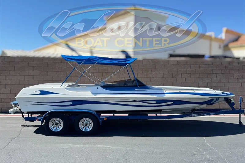 The Image of 2007 Commander 2300LX boat with blue accents on a trailer at Inland Boat Center. - 0