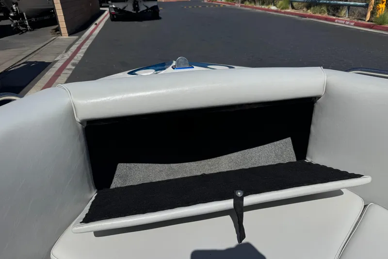 Slide: The Image of Storage compartment of a 2007 Commander 2300LX boat, open and empty. - 12