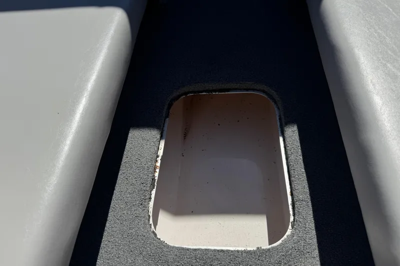 Slide: The Image of Boat interior compartment of a 2007 Commander 2300LX, showing storage area. - 13