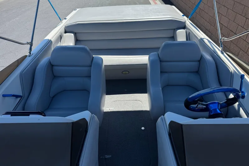 Slide: The Image of 2007 Commander 2300LX boat interior with gray seating and blue steering wheel. - 14