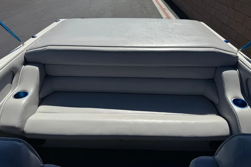 Slide: The Image of Rear seating area of a 2007 Commander 2300LX boat with gray upholstery and cup holders. - 15