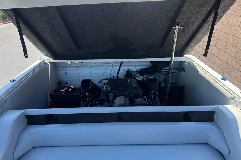 Slide: The Image of Open engine compartment of a 2007 Commander 2300LX boat, showcasing the engine details. - 16