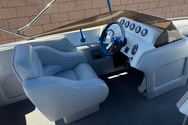 Slide: The Image of Interior of a 2007 Commander 2300LX boat with sleek dashboard and comfortable seating. - 21