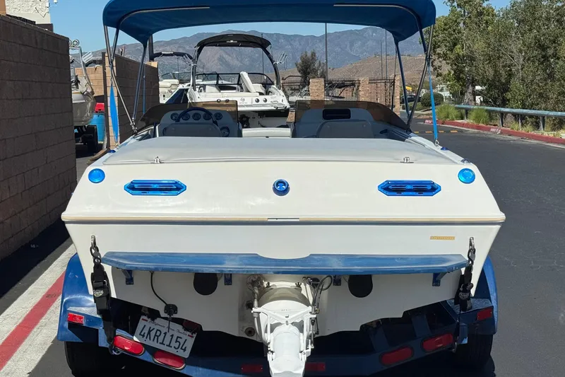 Slide: The Image of 2007 Commander 2300LX boat on trailer, rear view, parked outdoors. - 4