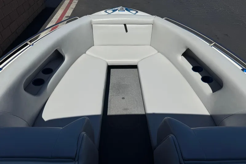 Slide: The Image of Interior view of a 2007 Commander 2300LX boat with gray seating and cup holders. - 8